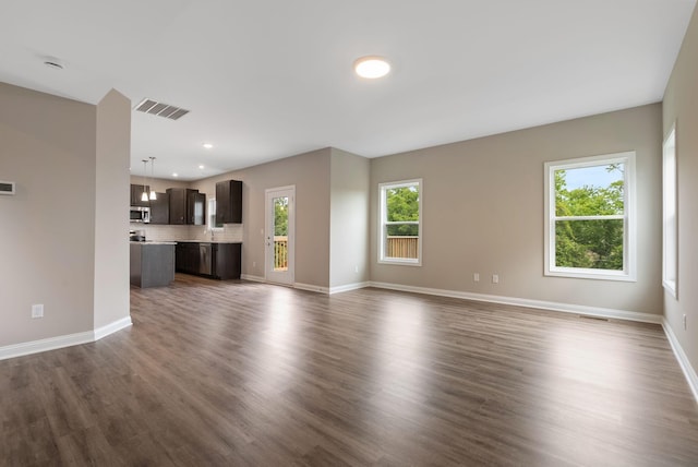 unfurnished living room featuring dark hardwood / wood-style flooring