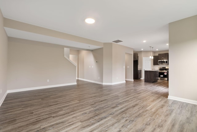 unfurnished living room with dark hardwood / wood-style flooring