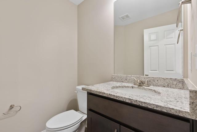 bathroom with toilet and vanity