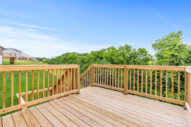 wooden terrace featuring a yard