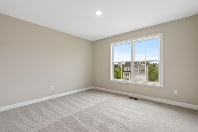 unfurnished room featuring light colored carpet