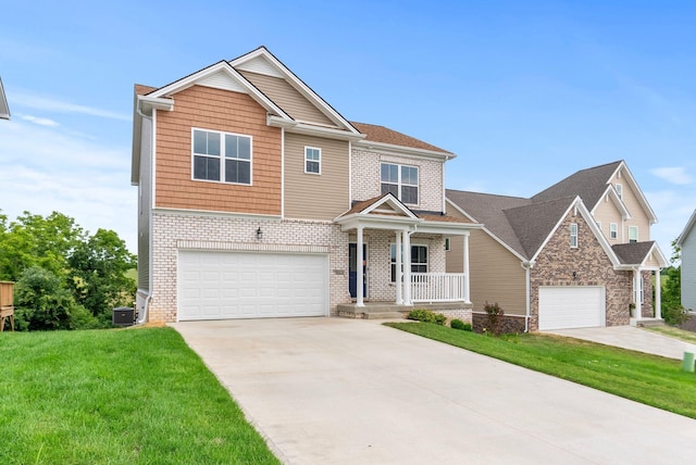 craftsman-style home with a porch, central AC unit, a front lawn, and a garage