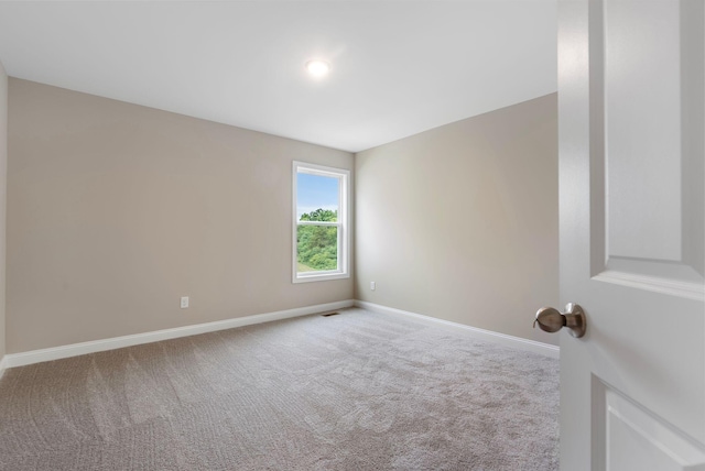 empty room featuring light carpet