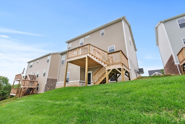 rear view of property featuring a deck and a lawn