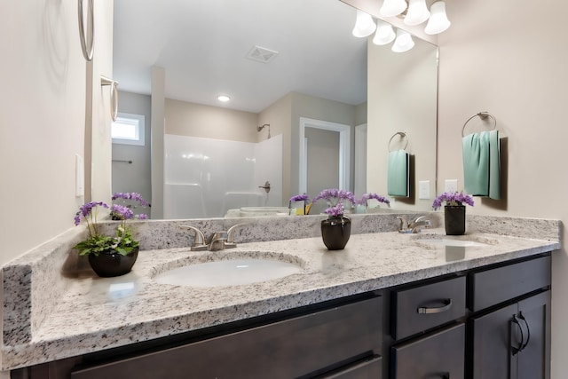 bathroom featuring vanity and walk in shower