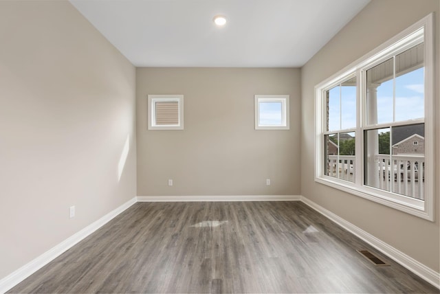 empty room featuring dark hardwood / wood-style flooring