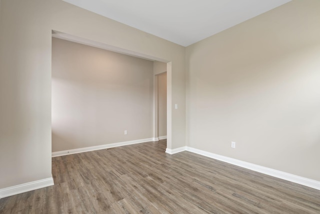 empty room with hardwood / wood-style flooring