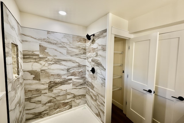 bathroom with tiled shower