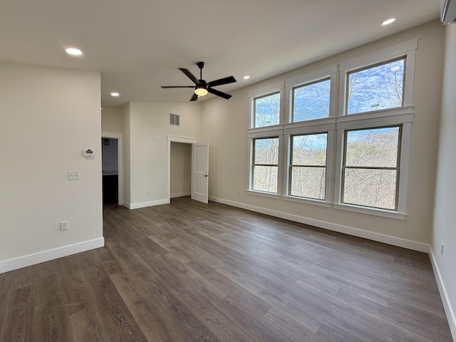 spare room with dark wood-type flooring, recessed lighting, visible vents, and baseboards