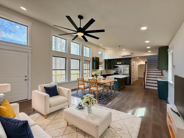 living area featuring recessed lighting, stairway, and wood finished floors