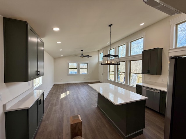 kitchen featuring a kitchen island, open floor plan, light countertops, appliances with stainless steel finishes, and dark wood finished floors