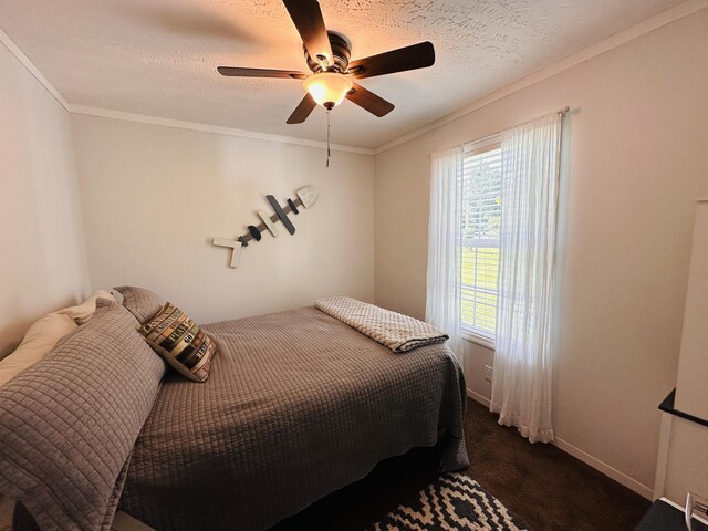 carpeted bedroom featuring a textured ceiling, ceiling fan, and crown molding