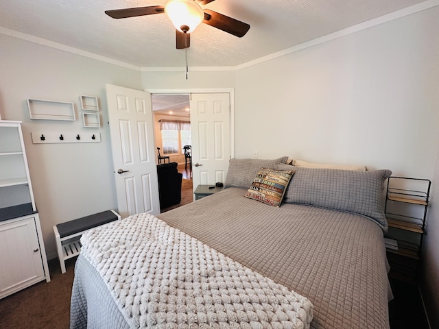 bedroom featuring a textured ceiling, dark carpet, ceiling fan, and crown molding