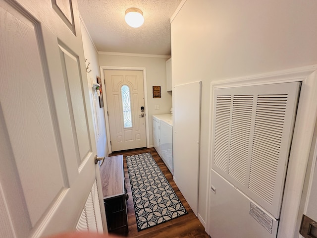 entryway with washing machine and clothes dryer, dark hardwood / wood-style floors, a textured ceiling, and ornamental molding