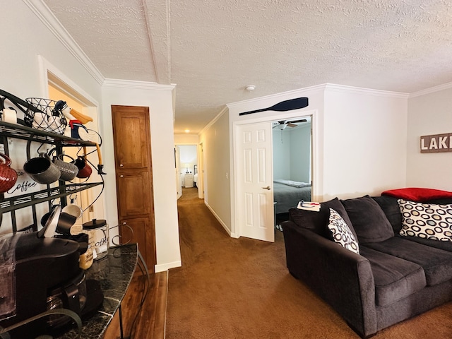 living room featuring ceiling fan, dark carpet, ornamental molding, and a textured ceiling