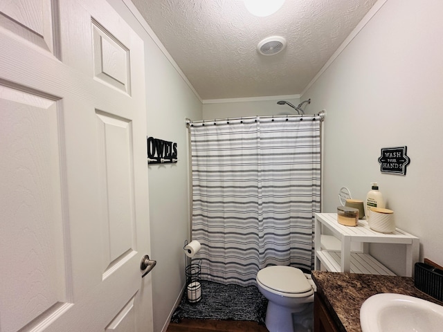 bathroom with toilet, vanity, a textured ceiling, and ornamental molding