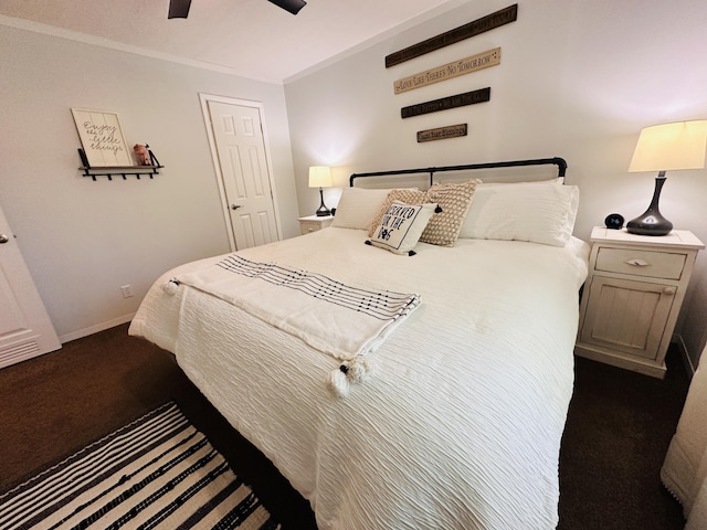 bedroom with ceiling fan and dark carpet