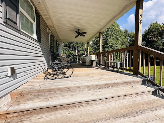 deck featuring ceiling fan and a grill