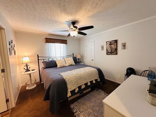 bedroom featuring dark colored carpet, a textured ceiling, ceiling fan, and crown molding