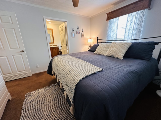 carpeted bedroom with ensuite bath, ceiling fan, and ornamental molding