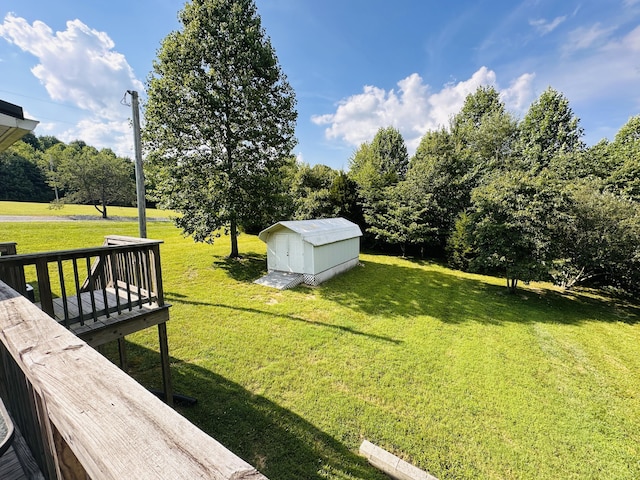 view of yard with a shed and a deck