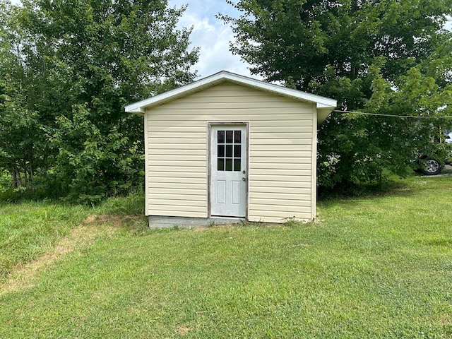 view of outbuilding with a lawn