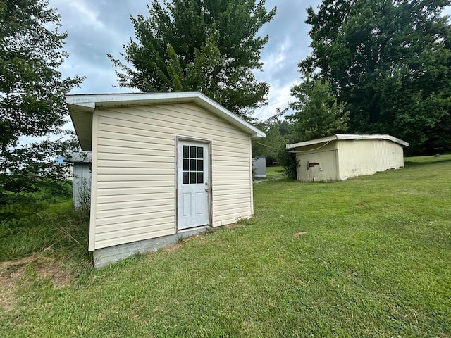 view of outbuilding featuring a yard