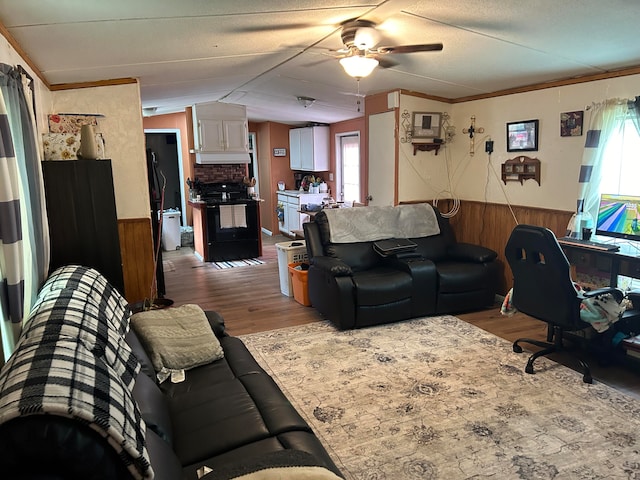 living room featuring crown molding, hardwood / wood-style floors, and a wealth of natural light