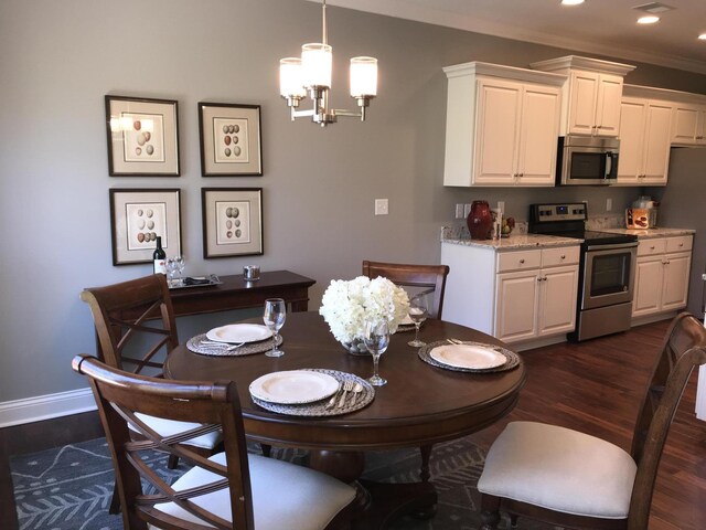 dining space featuring ornamental molding, dark wood-type flooring, and a chandelier