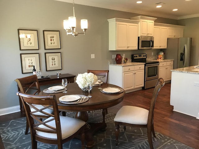 dining space with a notable chandelier, dark hardwood / wood-style flooring, and crown molding