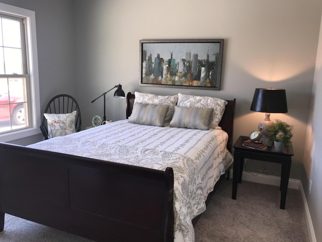 carpeted bedroom with multiple windows