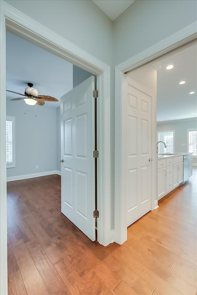 corridor with light hardwood / wood-style floors