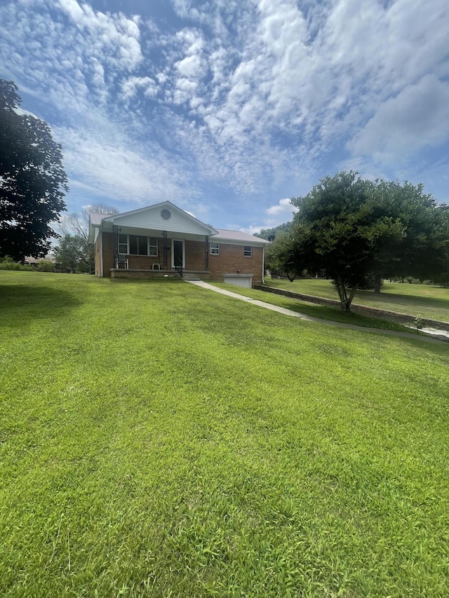 view of front of house featuring a garage and a front lawn