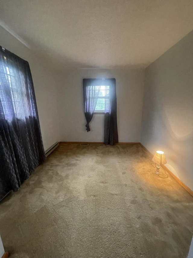 carpeted empty room featuring a textured ceiling