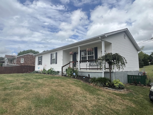 view of front facade with covered porch and a front lawn