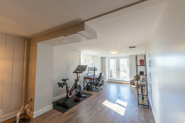 exercise area with wood-type flooring and french doors