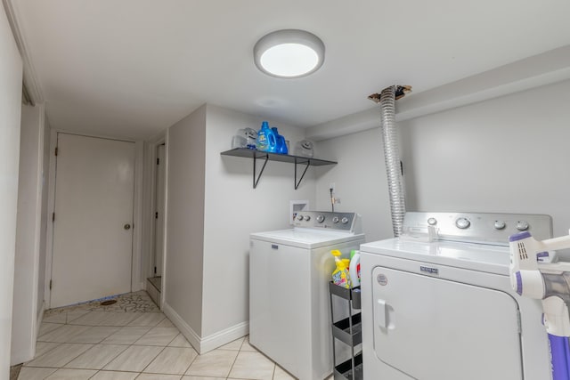 laundry room featuring light tile patterned flooring and washer and clothes dryer