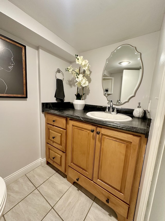 bathroom featuring tile patterned floors, toilet, and vanity