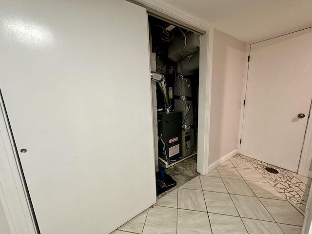 hall featuring heating unit and light tile patterned floors