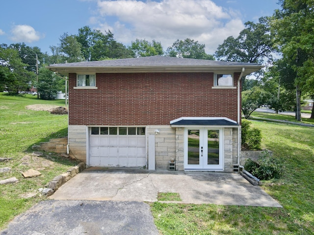 exterior space featuring a garage, a front yard, and french doors