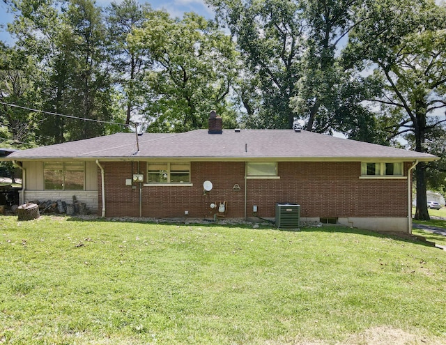 back of house featuring cooling unit and a yard