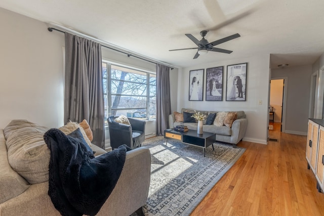 living room featuring ceiling fan and light wood-type flooring