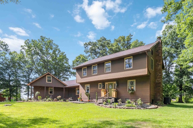 view of front facade with central AC and a front lawn