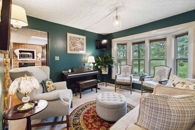 carpeted living room with a fireplace and a textured ceiling