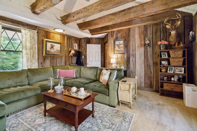 carpeted living room featuring beam ceiling and wood walls