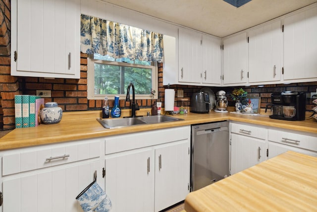 kitchen with white cabinetry, dishwasher, sink, and tasteful backsplash