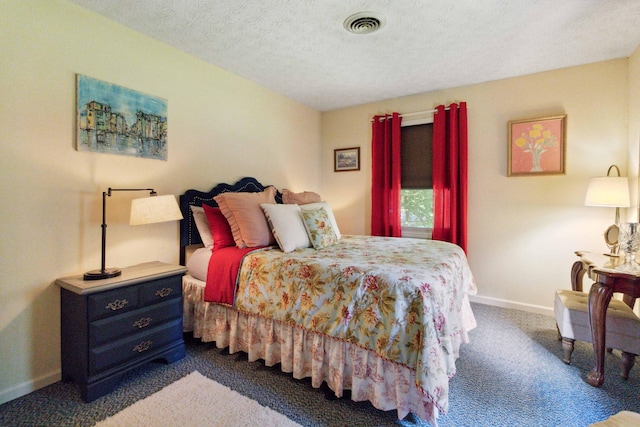 carpeted bedroom with a textured ceiling