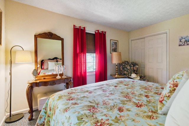 bedroom with a textured ceiling and a closet