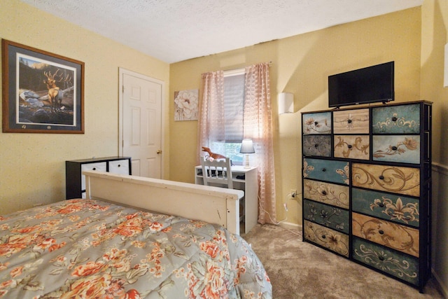 bedroom with light carpet and a textured ceiling