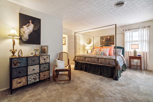 bedroom featuring carpet flooring and a textured ceiling